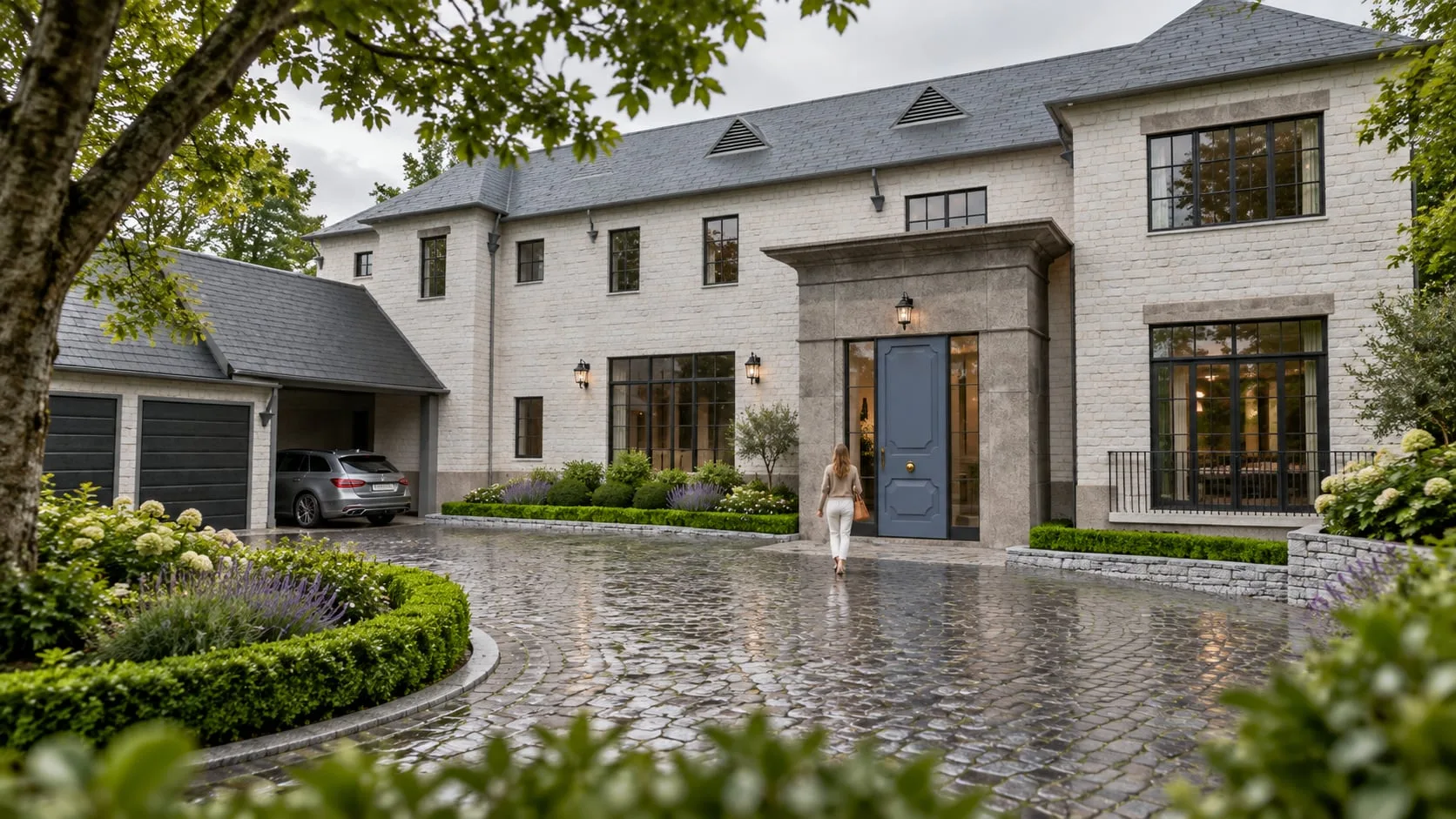 The house from the drive with the garage wing and clipped hedging