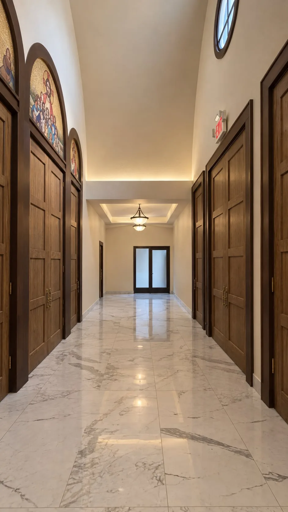 Corridor lined with timber doors under a single pendant light