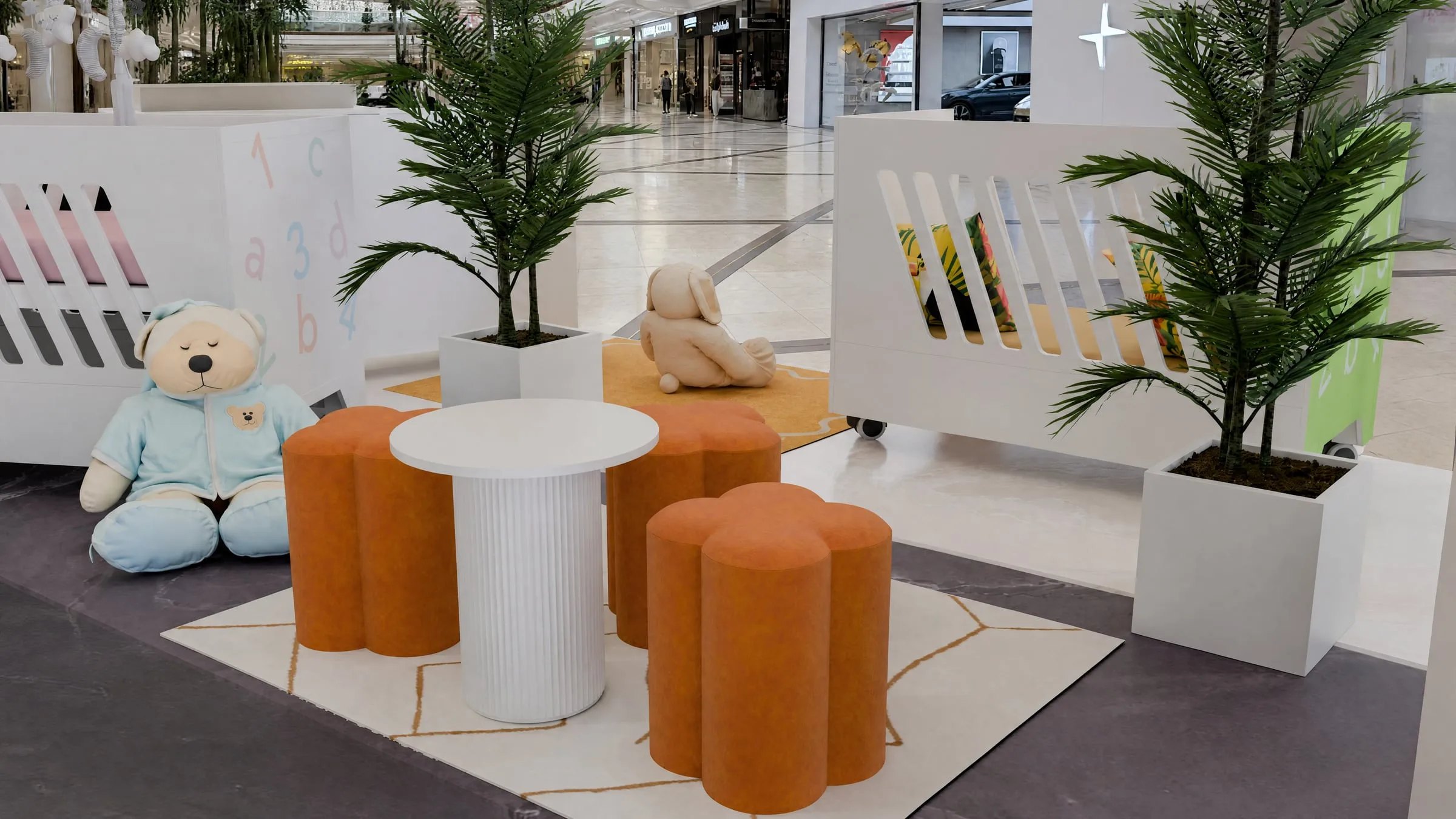 Seating area with orange stools, a teddy bear and a planted corner