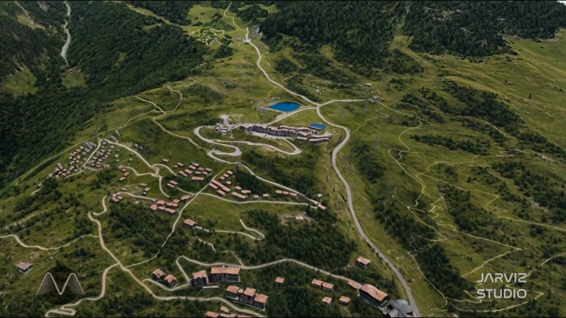 The same mountain in summer, green and tree-covered, the resort village and its roads laid out below the ridge